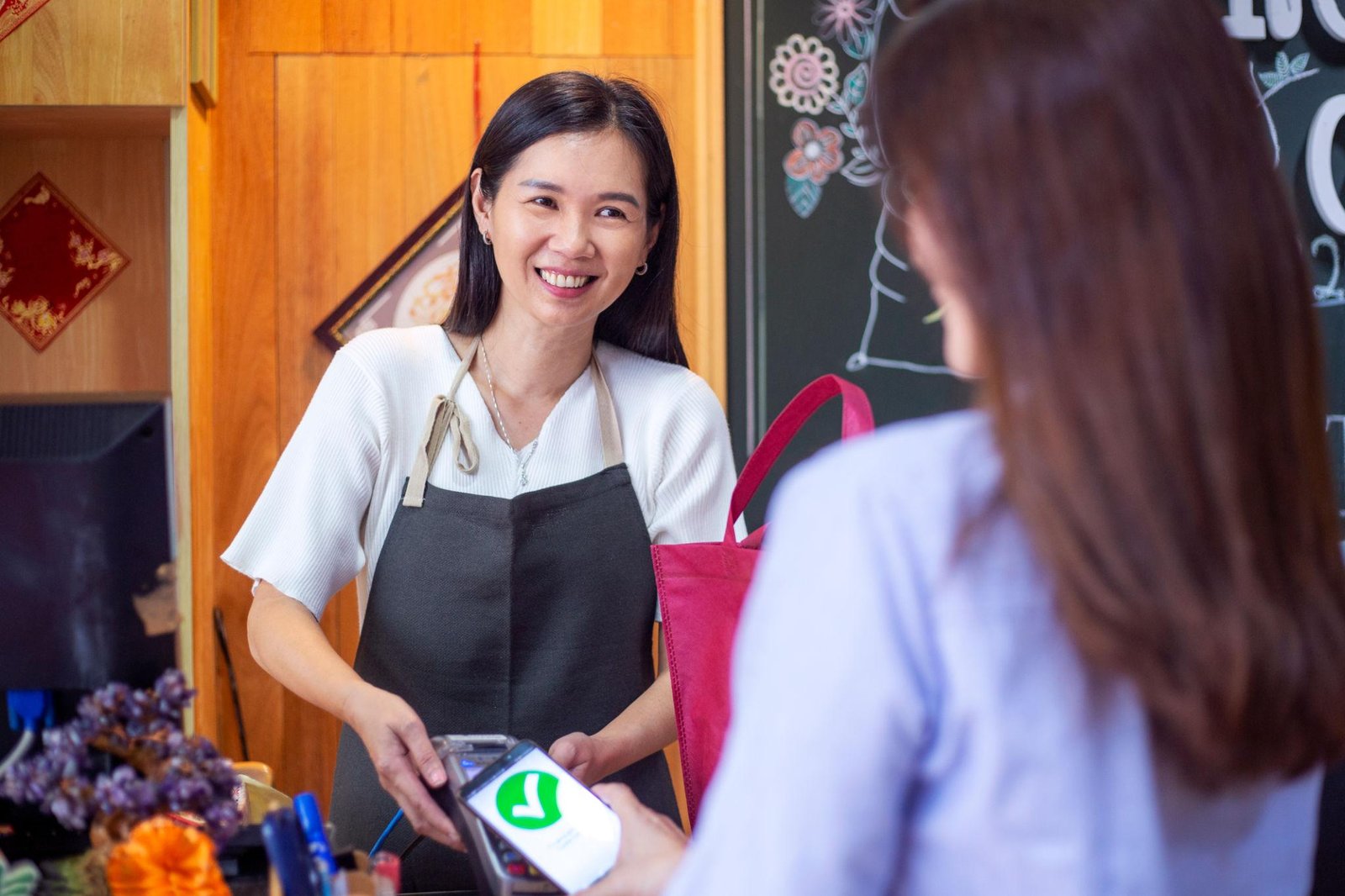 Modern POS system with integrated EFTPOS terminal processing contactless payment at retail checkout counter
