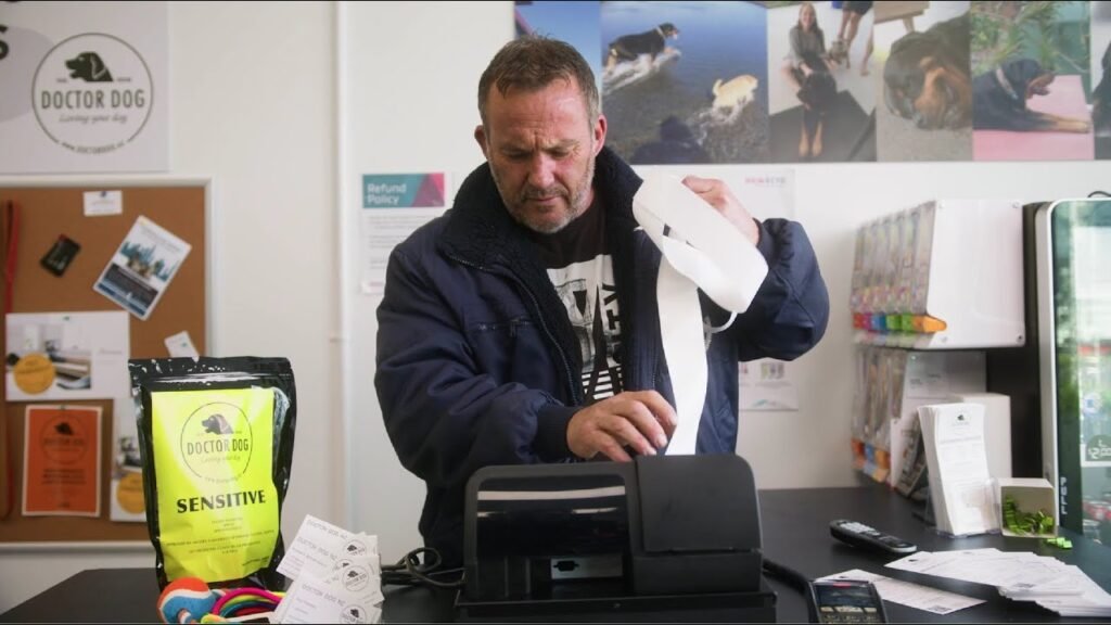 A businessman in Australia using EFTPOS machine